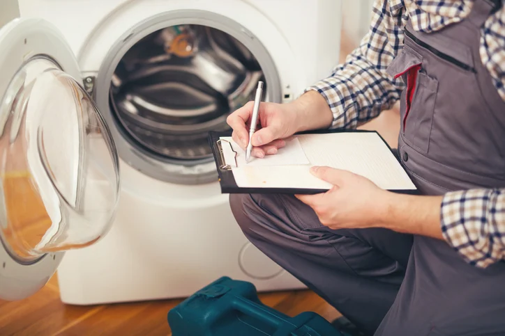 HomeHalo technician documenting an appliance diagnosis during an in-home service visit